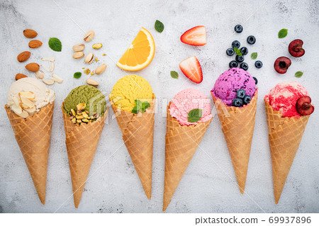 Various of ice cream flavor in cones blueberry ,pistachio ,almond ,orange and cherry setup on white stone background . Summer and Sweet menu concept. 69937896