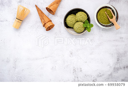 Matcha green tea ice cream with waffle cone and mint leaves set Matcha green tea ice cream with waffle cone and mint leaves set 69938079