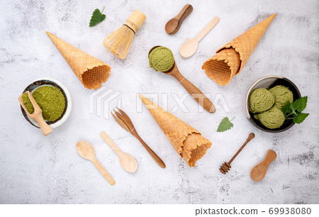 Matcha green tea ice cream with waffle cone and mint leaves set Matcha green tea ice cream with waffle cone and mint leaves set 69938080