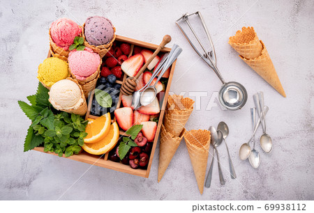Various of ice cream flavor in cones with berries in wooden box 69938112