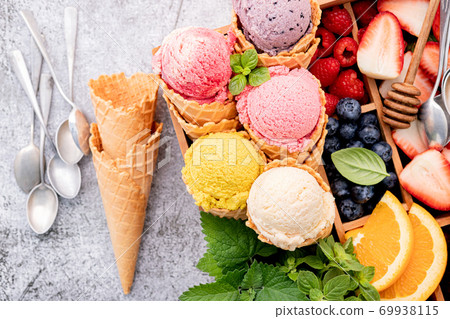 Various of ice cream flavor in cones with berries in wooden box 69938115