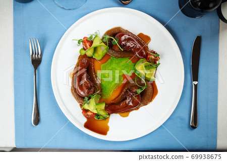 Lamb tongues with caramelized onion puree Lamb tongues with caramelized onion puree 69938675