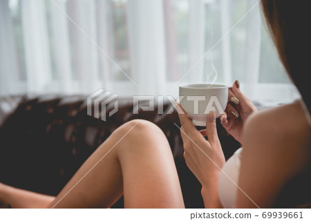 Young asian woman relaxing on the sofa at home. Young asian woman relaxing on the sofa at home. 69939661