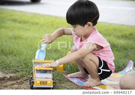Children playing in the dirt at the park Children playing in the dirt at the park 69940217