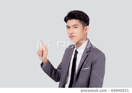 Portrait young asian business man pointing and presenting isolated on white background. Portrait young asian business man pointing and presenting isolated on white background. 69940851
