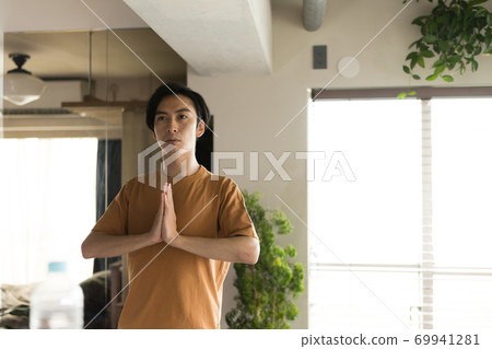 Men doing yoga at home Men doing yoga at home 69941281