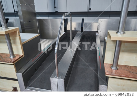 Check-in counter and baggage conveyor at an airport 69942058