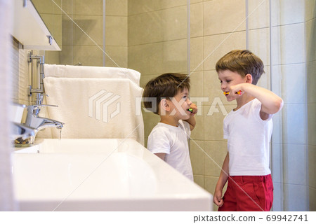 Two brothers brush my teeth in the bathroom.The beginning of a new day 69942741