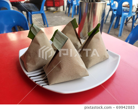 Nasi lemak. Is a signature food in Malaysia. Often eaten as breakfast. Nasi lemak is usually served with sambal, eggs and anchovies. 69942883