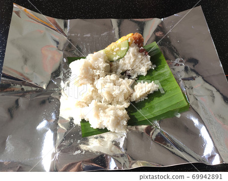 Nasi lemak. Is a signature food in Malaysia. Often eaten as breakfast. Nasi lemak is usually served with sambal, eggs and anchovies. Nasi lemak. Is a signature food in Malaysia. Often eaten as breakfast. Nasi lemak is usually served with sambal, eggs and anchovies. 69942891