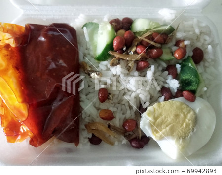 Nasi lemak. Is a signature food in Malaysia. Often eaten as breakfast. Nasi lemak is usually served with sambal, eggs and anchovies. Nasi lemak. Is a signature food in Malaysia. Often eaten as breakfast. Nasi lemak is usually served with sambal, eggs and anchovies. 69942893