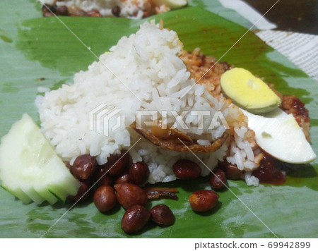 Nasi lemak. Is a signature food in Malaysia. Often eaten as breakfast. Nasi lemak is usually served with sambal, eggs and anchovies. 69942899