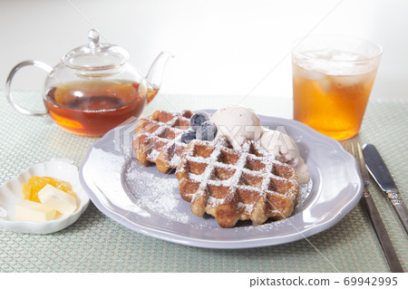 Waffles and iced tea served on a plate Waffles and iced tea served on a plate 69942995
