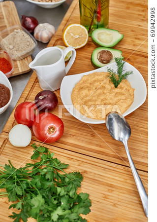 Many different spices, vegetables and ingredients, and fresh herbs for making homemade sauce 69942998