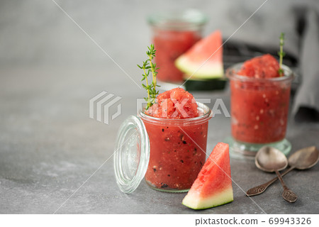 watermelon smoothie with basil and thyme in glass jars watermelon smoothie with basil and thyme in glass jars 69943326