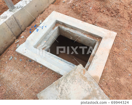 SEREMBAN, MALAYSIA -AUGUST 6, 2020: Utility services manhole and underground pipes under construction at the construction site. In-situ construction by workers based on infrastructure engineer design. 69944324