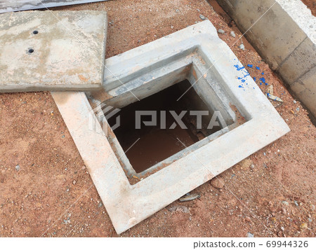 SEREMBAN, MALAYSIA -AUGUST 6, 2020: Utility services manhole and underground pipes under construction at the construction site. In-situ construction by workers based on infrastructure engineer design. 69944326