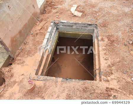 SEREMBAN, MALAYSIA -AUGUST 6, 2020: Utility services manhole and underground pipes under construction at the construction site. In-situ construction by workers based on infrastructure engineer design. 69944329