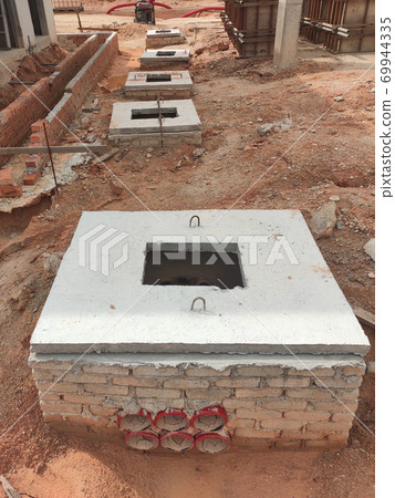 SEREMBAN, MALAYSIA -AUGUST 6, 2020: Utility services manhole and underground pipes under construction at the construction site. In-situ construction by workers based on infrastructure engineer design. 69944335