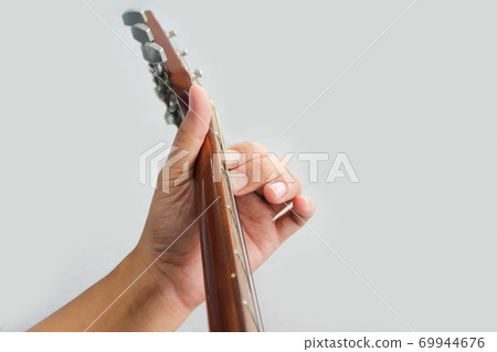 Acoustic guitar guitarist playing. Musical instrument with performer hands Acoustic guitar guitarist playing. Musical instrument with performer hands 69944676