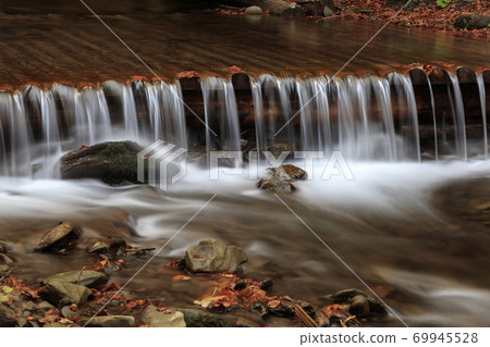 Beautiful streams and small waterfalls near the big Carpathian waterfall Shypit. In the autumn. Beautiful streams and small waterfalls near the big Carpathian waterfall Shypit. In the autumn. 69945528