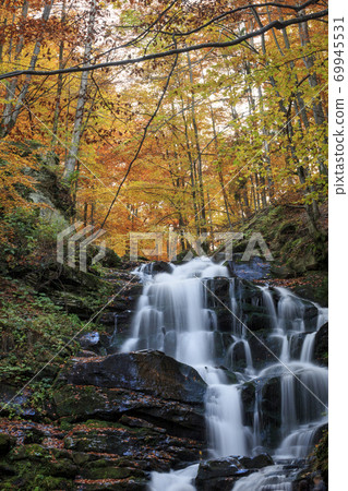 Landscape of waterfall in the Ukrainian Carpathian Mountains on the long exposure in autumn Landscape of waterfall in the Ukrainian Carpathian Mountains on the long exposure in autumn 69945531