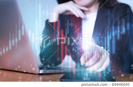 Asian business woman in suit with hologram financial graph 69946095