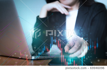 Asian business woman in suit with hologram financial graph 69946096