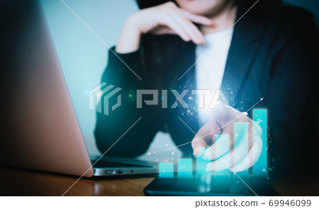 Asian business woman in suit with hologram financial graph 69946099