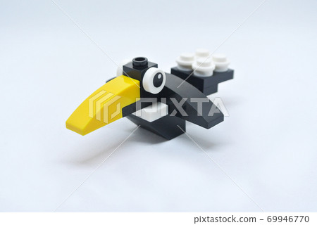 The shape of a crow is made of colorful plastic toy blocks. The shape of a crow is made of colorful plastic toy blocks. 69946770