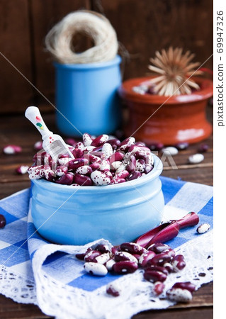 Violet with dots beans in ceramic bowl. Swallow beans. Vegetables for healthy eating. Organic food. Diet 69947326
