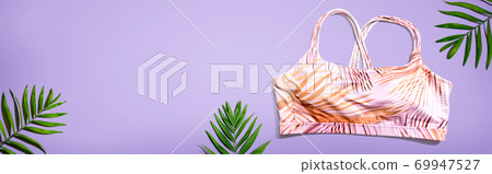 Fitness theme with a sport bra and tropical plants 69947527