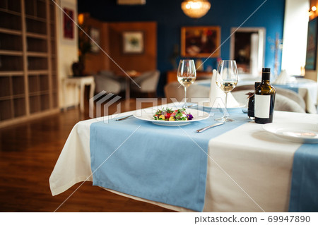 Restaurant table served with spanish tomato salad Restaurant table served with spanish tomato salad 69947890