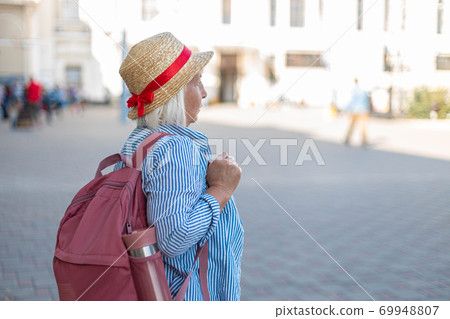 Traveler woman tourist in blue casual clothes, hat with tourist backpack. A passenger traveling abroad for a weekend trip. Travel concept 69948807