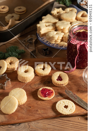 Filling traditional Linzer Christmas cookies with jam Filling traditional Linzer Christmas cookies with jam 69949131