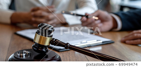 Contract decree of divorce (dissolution or cancellation) of marriage, husband and wife during divorce process and signing of divorce contract, Wedding ring Contract decree of divorce (dissolution or cancellation) of marriage, husband and wife during divorce process and signing of divorce contract, Wedding ring 69949474