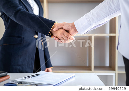 Greeting new colleagues, Handshake while job interviewing, Female candidate shaking hands with Interviewer or employer after a job interview, employment and recruitment concept Greeting new colleagues, Handshake while job interviewing, Female candidate shaking hands with Interviewer or employer after a job interview, employment and recruitment concept 69949529
