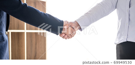 Greeting new colleagues, Handshake while job interviewing, Female candidate shaking hands with Interviewer or employer after a job interview, employment and recruitment concept Greeting new colleagues, Handshake while job interviewing, Female candidate shaking hands with Interviewer or employer after a job interview, employment and recruitment concept 69949530