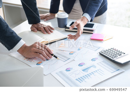 Business team are working with leader, Presentation to colleagues and business strategy and having a discussion, pointing to the graph and chart, success of cooperation partnership 69949547
