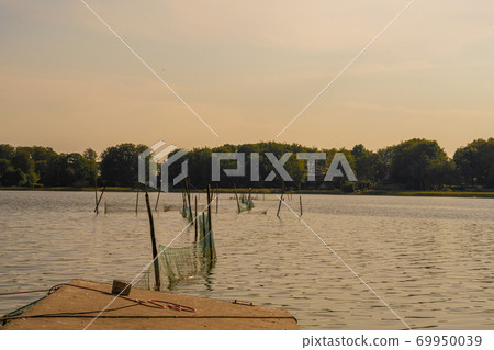 Beautiful sunset scenery of a fishing net in a lake one of the latest days of summer. Picture from Ringsjon, Scania, southern Sweden 69950039