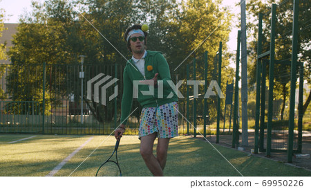 Funny freak man playing tennis ball 69950226