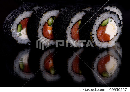 Fresh delicious beautiful sushi rolls on a dark background Fresh delicious beautiful sushi rolls on a dark background 69950337