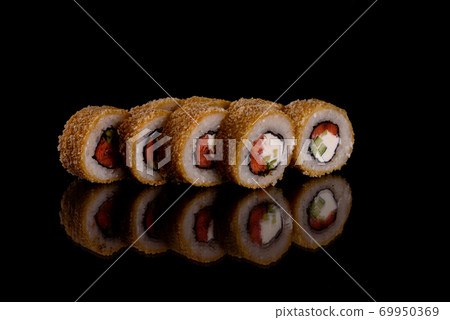 Fresh delicious beautiful sushi rolls on a dark background Fresh delicious beautiful sushi rolls on a dark background 69950369