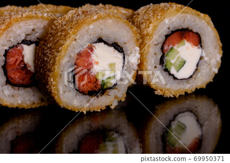 Fresh delicious beautiful sushi rolls on a dark background 69950371