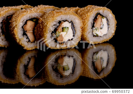 Fresh delicious beautiful sushi rolls on a dark background Fresh delicious beautiful sushi rolls on a dark background 69950372