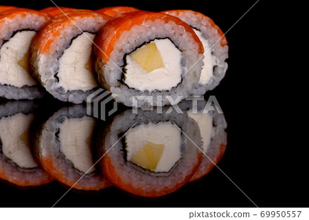 Fresh delicious beautiful sushi rolls on a dark background Fresh delicious beautiful sushi rolls on a dark background 69950557