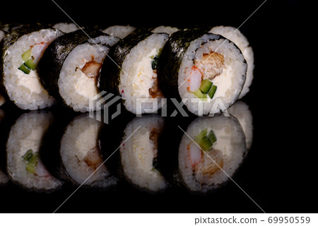 Fresh delicious beautiful sushi rolls on a dark background Fresh delicious beautiful sushi rolls on a dark background 69950559