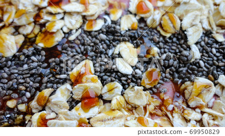 Vegan smoothie bowls with coconut flakes, chia seeds, almond and granola on pink background. Breakfast bowl with fruit and cereal, close-up, top view, healthy vegan food 69950829