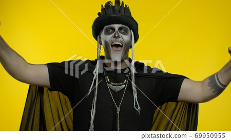 Happy creepy man with skeleton makeup celebrating win, emotionally rejoicing in victory success Happy creepy man with skeleton makeup celebrating win, emotionally rejoicing in victory success 69950955