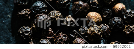 Black pepper closeup on luxury stone background as flat lay, dry food spices and recipe ingredient 69952001